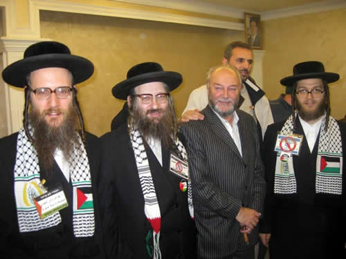 MP George Galloway poses with members of Neturei Karta